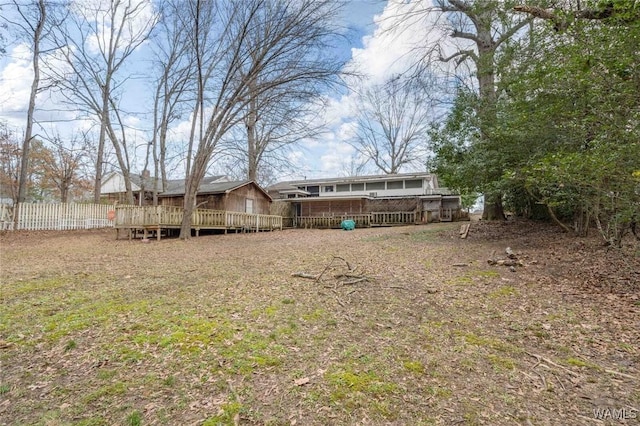 rear view of house featuring a wooden deck