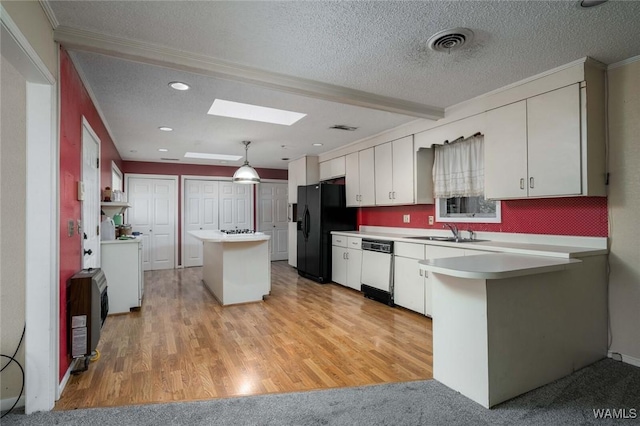 kitchen featuring white cabinetry, decorative light fixtures, and black fridge with ice dispenser