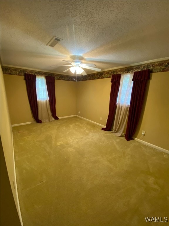 924 12th St SW, Fayette, AL 35555 - spare room featuring baseboards, a textured ceiling, light carpet, and ceiling fan