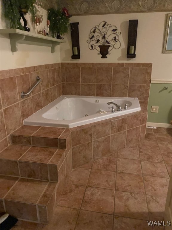 924 12th St SW, Fayette, AL 35555 - bathroom with a whirlpool tub and tile patterned floors