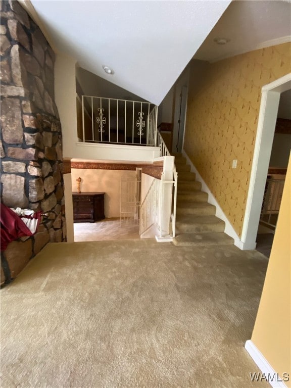924 12th St SW, Fayette, AL 35555 - unfurnished living room with carpet flooring, stairs, and lofted ceiling