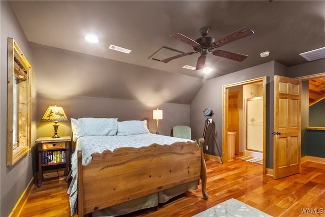 bedroom with ceiling fan, wood-type flooring, and vaulted ceiling