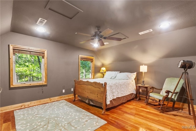 bedroom featuring hardwood / wood-style floors, ceiling fan, and lofted ceiling