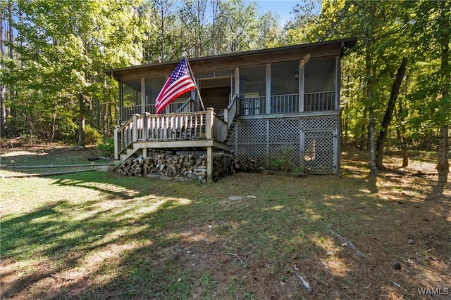 exterior space featuring a sunroom and a front yard