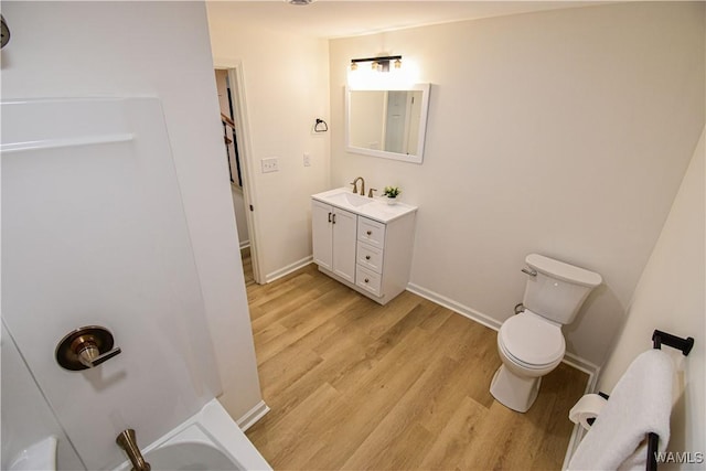 full bathroom featuring vanity, toilet, wood finished floors, and baseboards