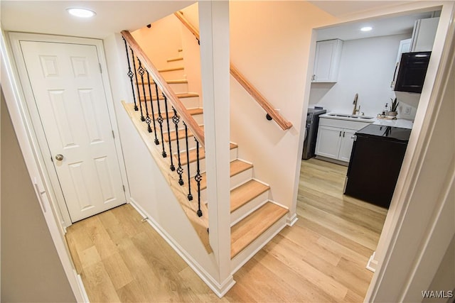 stairway with recessed lighting, wood finished floors, and baseboards