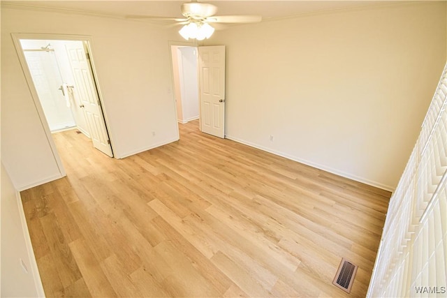 unfurnished bedroom featuring visible vents, ornamental molding, a ceiling fan, light wood-style floors, and baseboards