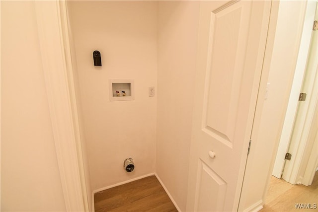 laundry room featuring laundry area, hookup for a washing machine, light wood-type flooring, and baseboards