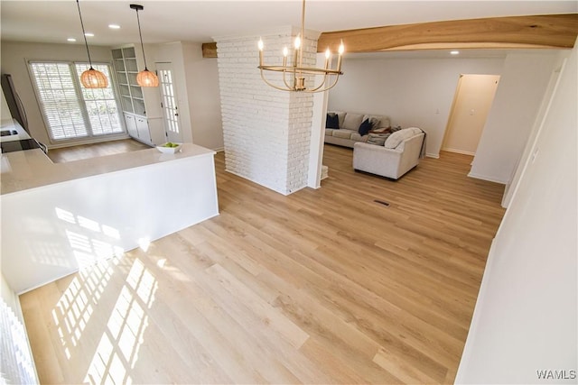 interior space with an inviting chandelier, recessed lighting, light wood-style floors, and beam ceiling