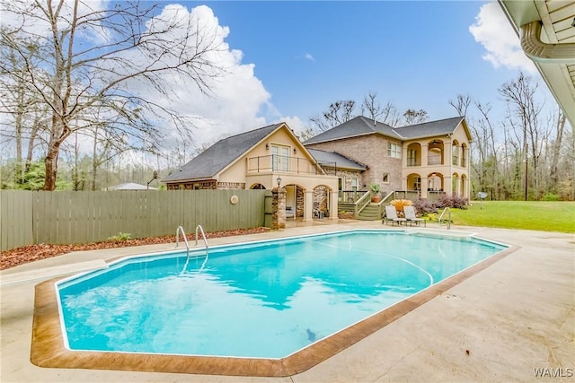 view of swimming pool featuring a patio area, fence, and a fenced in pool