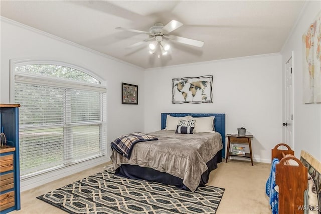 bedroom featuring baseboards, carpet flooring, a ceiling fan, and crown molding