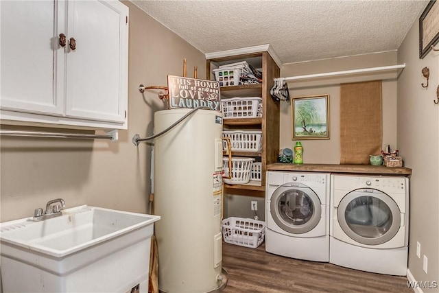 washroom featuring dark wood-style flooring, a textured ceiling, washing machine and dryer, water heater, and a sink