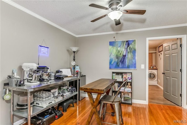 office area featuring a textured ceiling, washer / clothes dryer, wood finished floors, and ornamental molding