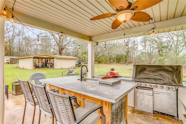 view of patio / terrace with an outdoor structure and a sink