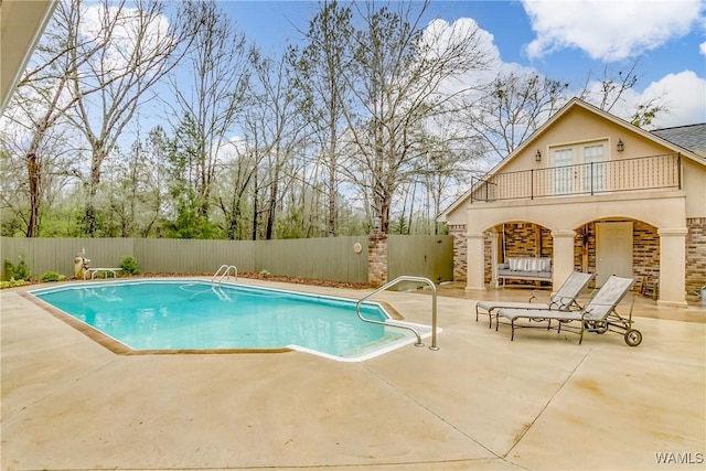 view of pool featuring a fenced in pool, a fenced backyard, and a patio