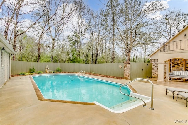 view of swimming pool with a patio area, a fenced backyard, and a fenced in pool