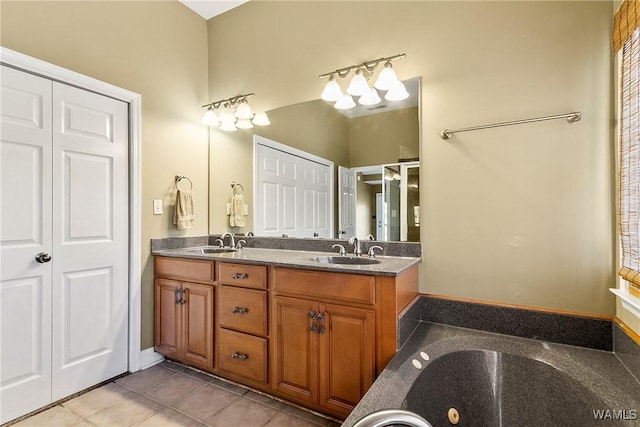 bathroom with vanity, tile patterned floors, and a washtub