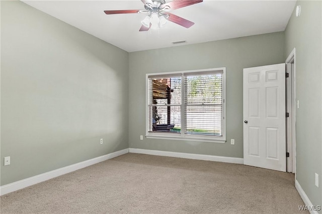 unfurnished room featuring light carpet and ceiling fan