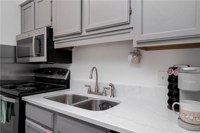 1009 12th St Unit 22, Tuscaloosa, AL 35401 - kitchen featuring black electric range, stainless steel microwave, gray cabinets, and light stone counters