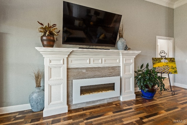 details with crown molding, wood-type flooring, and a tiled fireplace