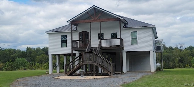 coastal home featuring a garage, a front yard, and a carport