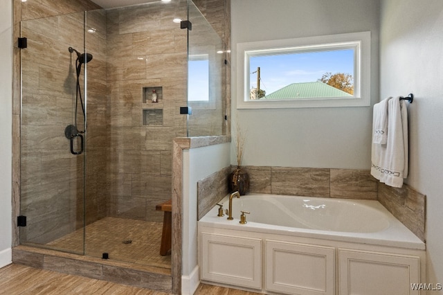 bathroom featuring hardwood / wood-style floors and separate shower and tub