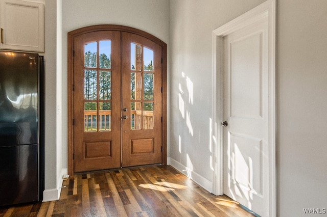 entrance foyer with french doors and dark wood-type flooring