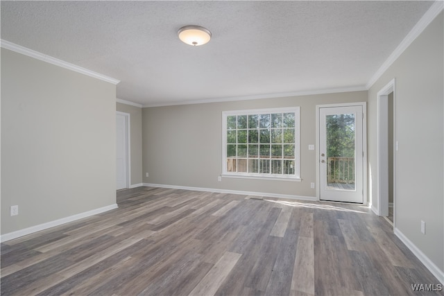 spare room featuring ornamental molding, hardwood / wood-style floors, and a textured ceiling