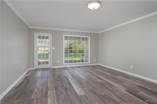 empty room with ornamental molding, a textured ceiling, and dark hardwood / wood-style flooring