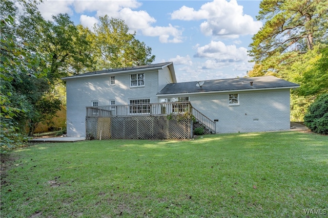 back of house featuring a wooden deck and a yard