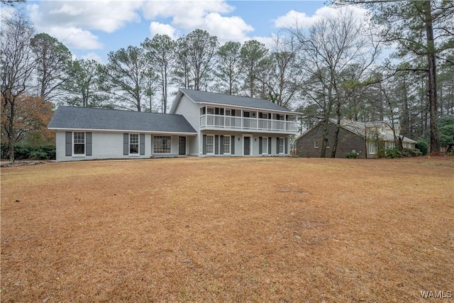 rear view of property with a yard