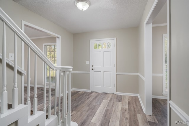 entrance foyer featuring light hardwood / wood-style flooring and a textured ceiling