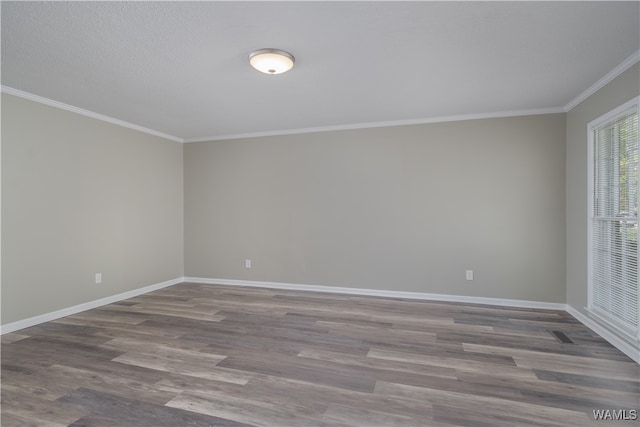 empty room with wood-type flooring and crown molding