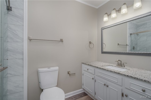 bathroom featuring ornamental molding, vanity, toilet, and an enclosed shower