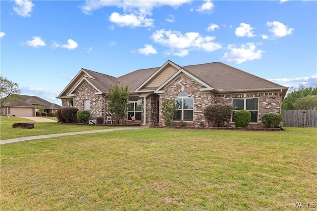 craftsman-style home with brick siding, a front lawn, and fence