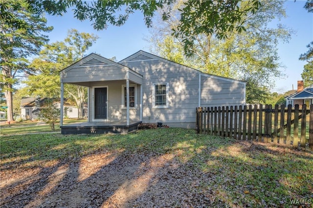 bungalow-style home with a front yard