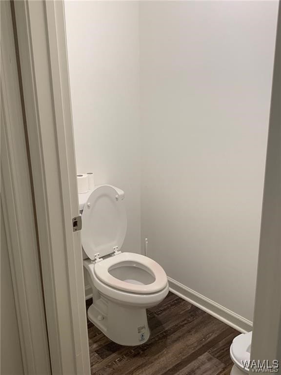 7106 Dowery Dell Way, Northport, AL 35473 - bathroom featuring baseboards, wood finished floors, and toilet