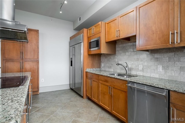 1018 Hackberry Ln Unit 404, Tuscaloosa, AL 35401 - kitchen with extractor fan, built in appliances, decorative backsplash, light stone countertops, and brown cabinetry