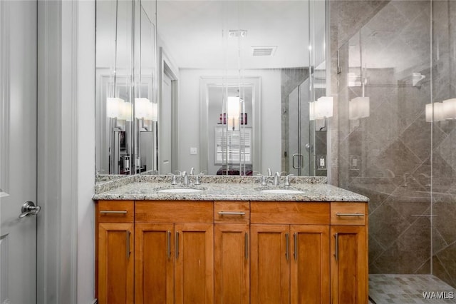 1018 Hackberry Ln Unit 404, Tuscaloosa, AL 35401 - bathroom with a stall shower and double vanity