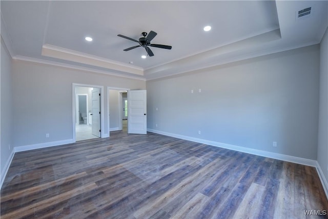 unfurnished bedroom with dark hardwood / wood-style floors, ceiling fan, ornamental molding, and a tray ceiling