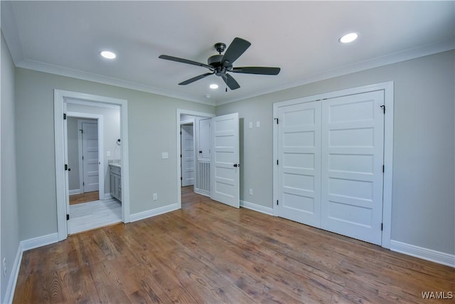 unfurnished bedroom with ceiling fan, a closet, ornamental molding, and light hardwood / wood-style flooring