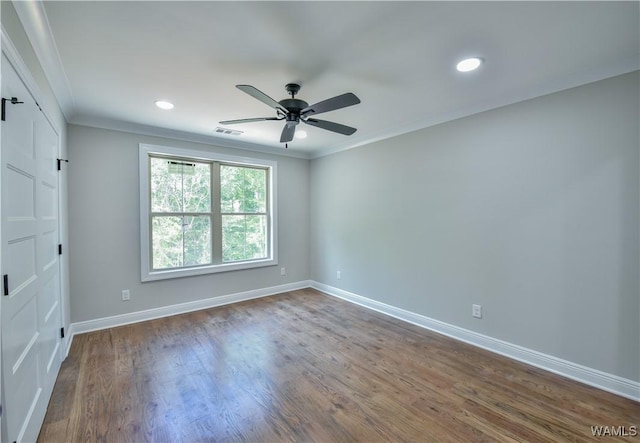 empty room with hardwood / wood-style floors, ceiling fan, and crown molding