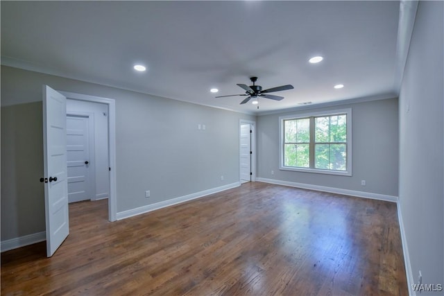 unfurnished room with ceiling fan, dark hardwood / wood-style floors, and ornamental molding