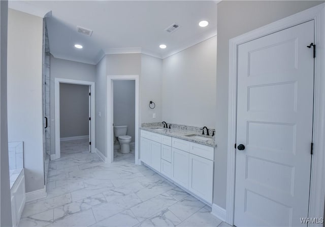 bathroom featuring a bathing tub, vanity, toilet, and ornamental molding