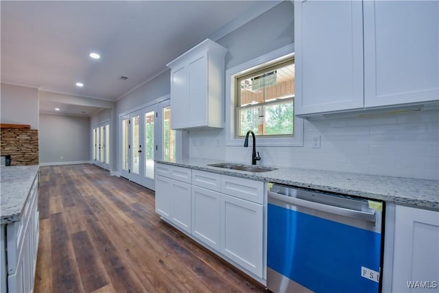 kitchen featuring dark hardwood / wood-style flooring, stainless steel dishwasher, ornamental molding, sink, and white cabinets