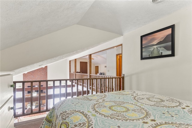 bedroom featuring a textured ceiling and lofted ceiling