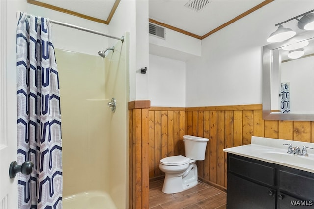 bathroom with wood walls, hardwood / wood-style floors, toilet, vanity, and ornamental molding