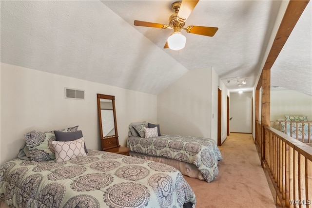 bedroom featuring a textured ceiling, light colored carpet, ceiling fan, and lofted ceiling