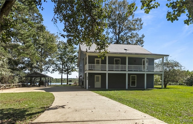 back of property with a gazebo and a yard