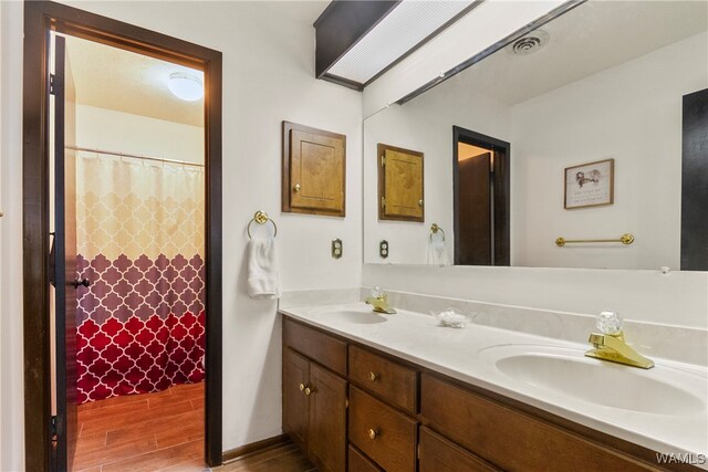 bathroom featuring hardwood / wood-style floors and vanity